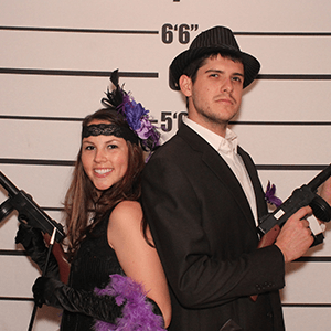 Nashville Murder Mystery party guests pose for mugshots
