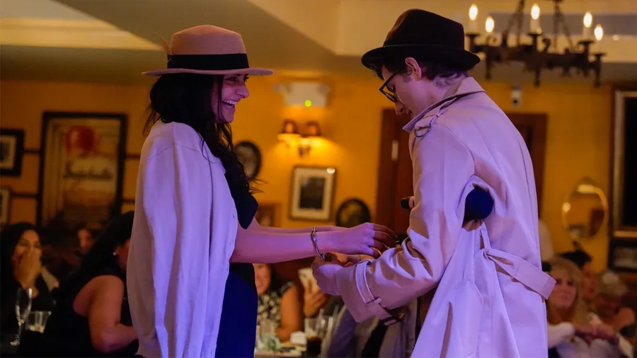 A Murder Mystery Company detective questioning a guest at a Nashville show